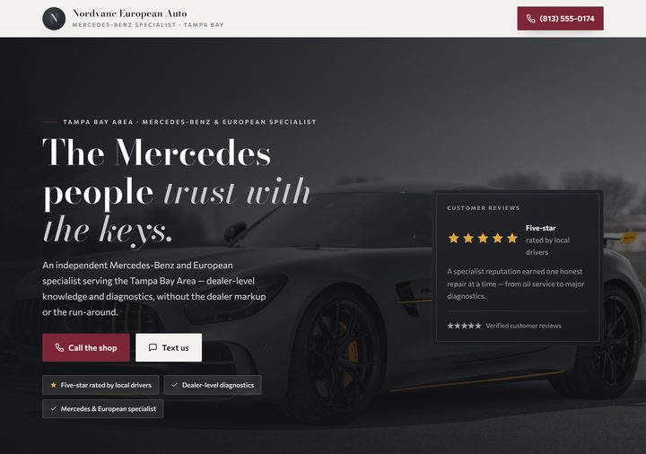 Auto repair template preview — graphite and porcelain with wine accents