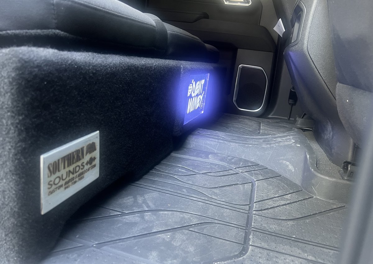 Finished trunk install with blue LED glow and a Voltage Row badge lighting up the enclosure