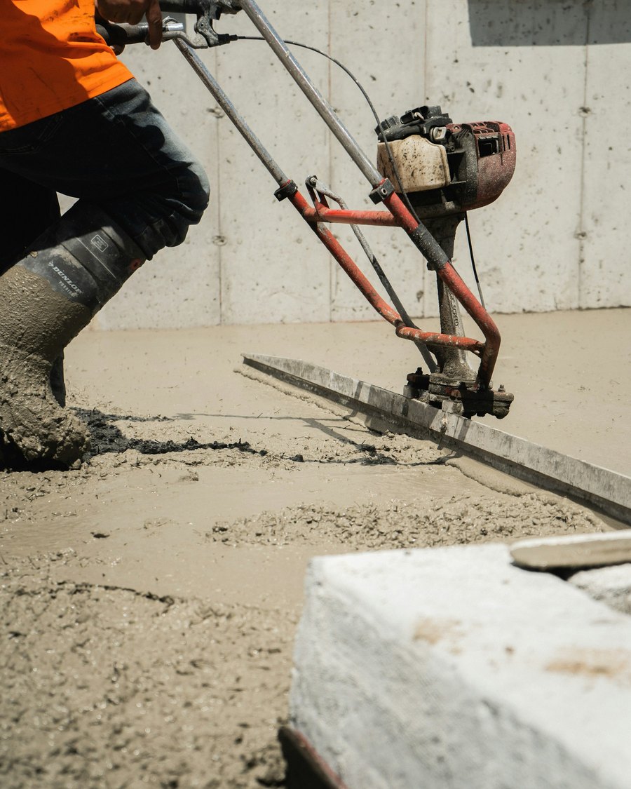 A Truline Concrete worker screeding and finishing a freshly poured concrete slab