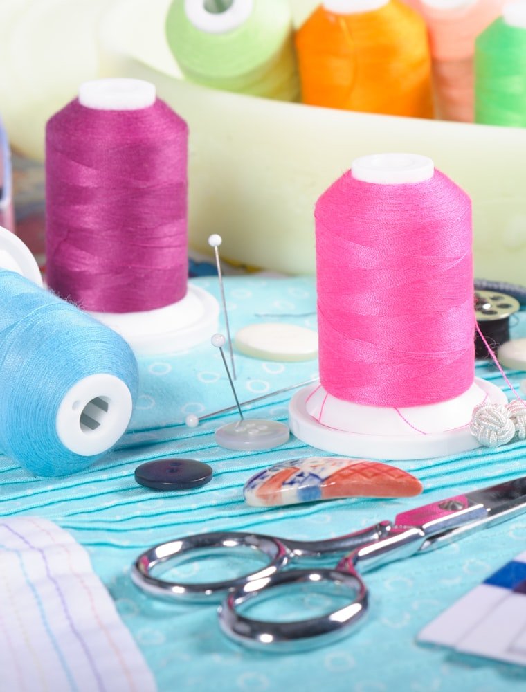 Colorful spools of thread and sewing supplies in the workshop