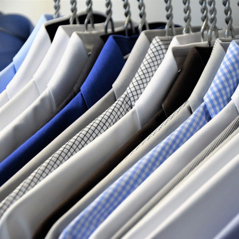 Freshly pressed dress shirts hanging on a rack