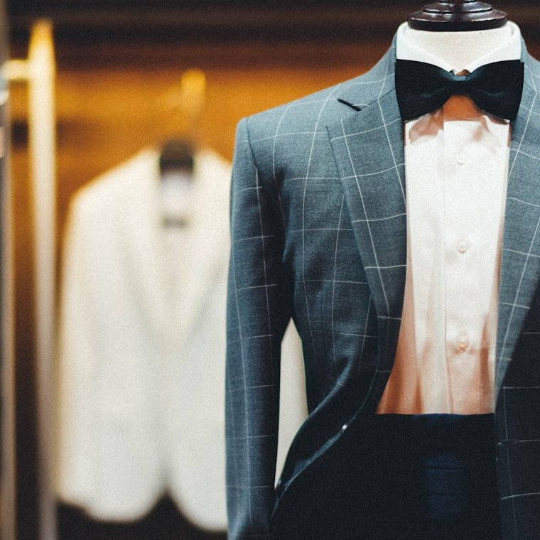 A sharply tailored suit displayed on a dress form