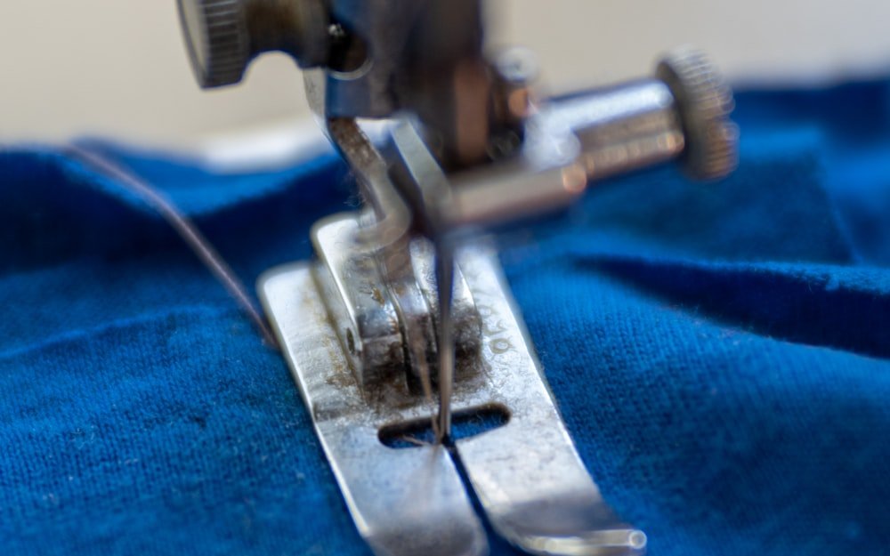 Sewing machine stitching a hem on a garment