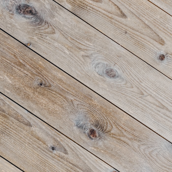 Close-up of weathered oak plank flooring showing tight seams and natural grain