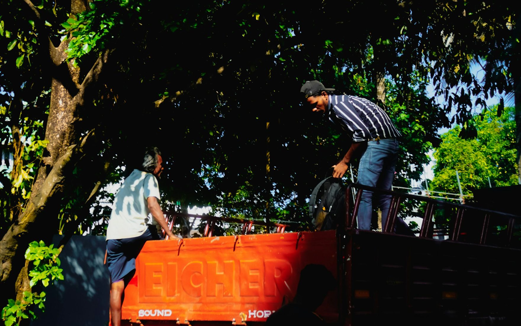 A junk removal crew loading unwanted items into a truck to haul away