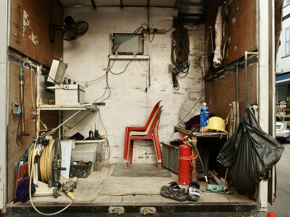 The open back of a work truck loaded up with items to be hauled off