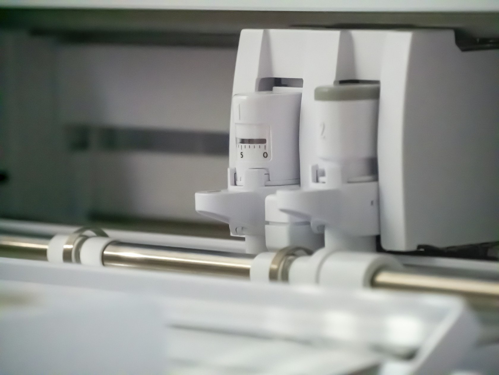 Vinyl cutter carriage tracking across a sheet of media on the plotter rail