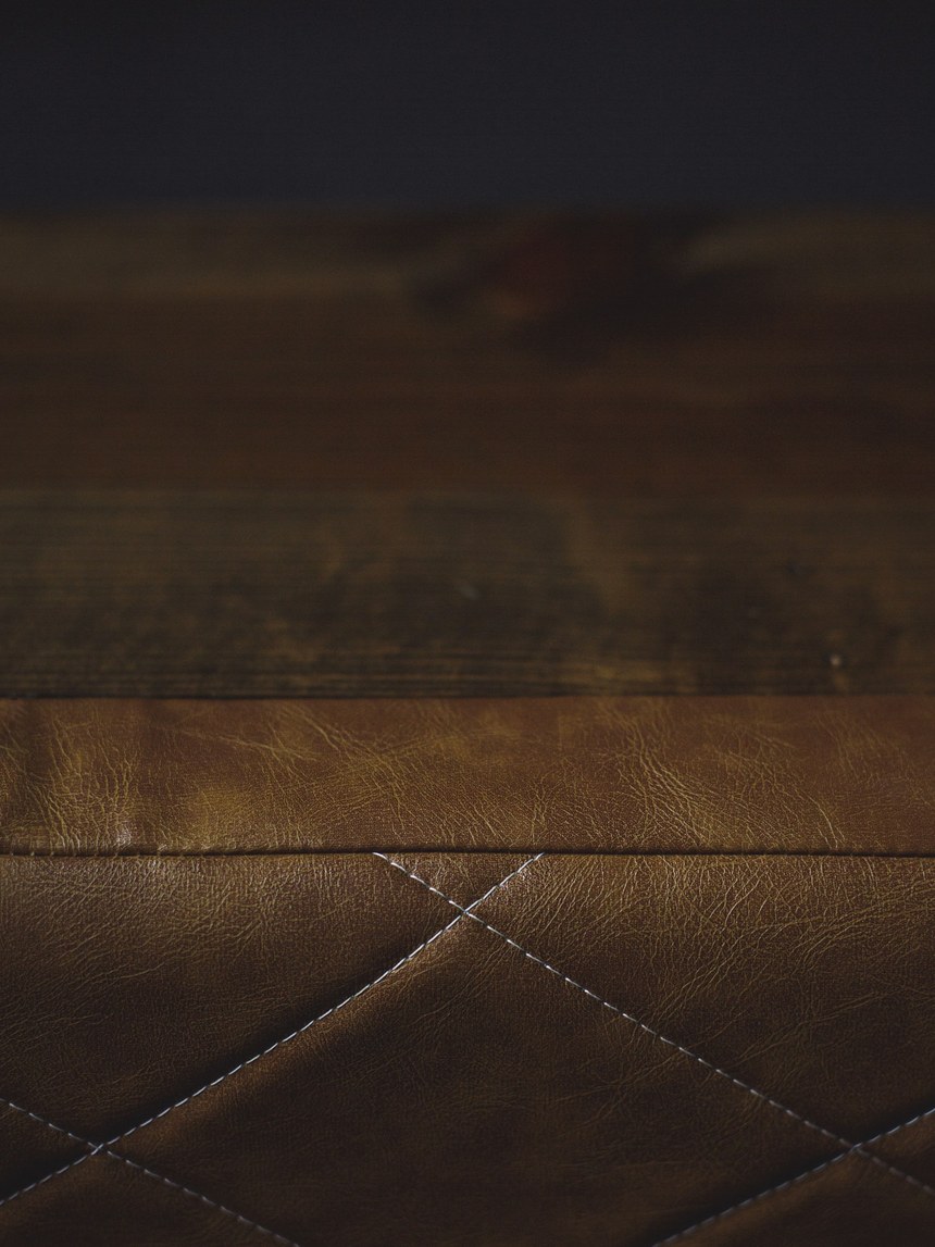 Close-up of hand-stitched diamond-pattern leather upholstery