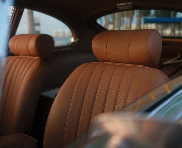 Restored classic car interior with tan leather and wood trim