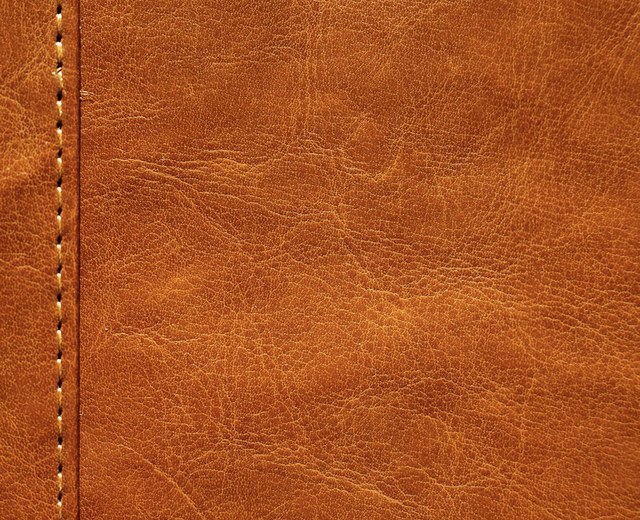 Full-grain tan leather with a clean stitched seam