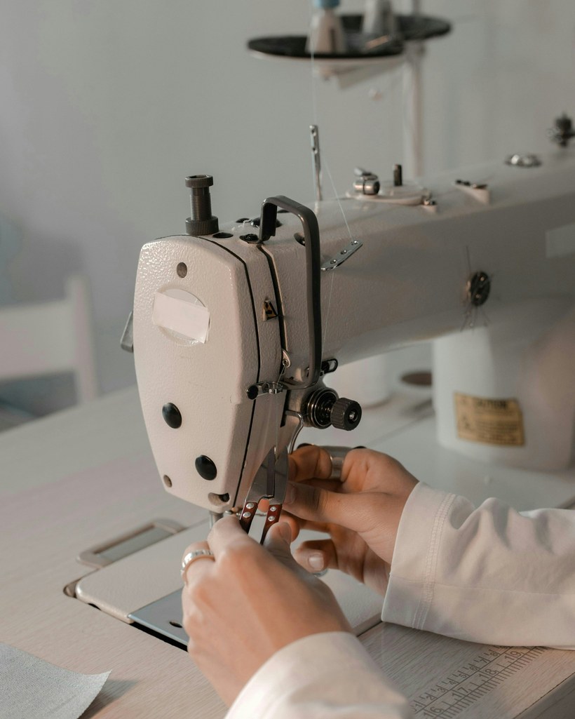 Upholsterer sewing leather on an industrial machine
