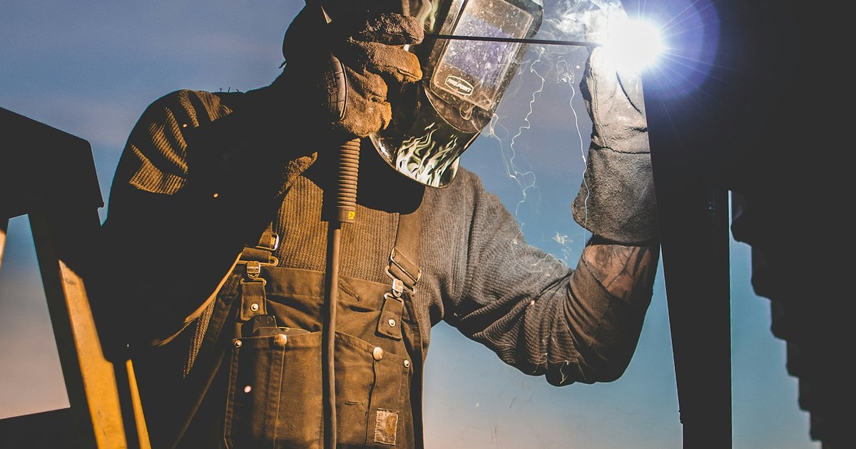 Mobile welding rig set up on a jobsite with sparks flying from a fresh weld