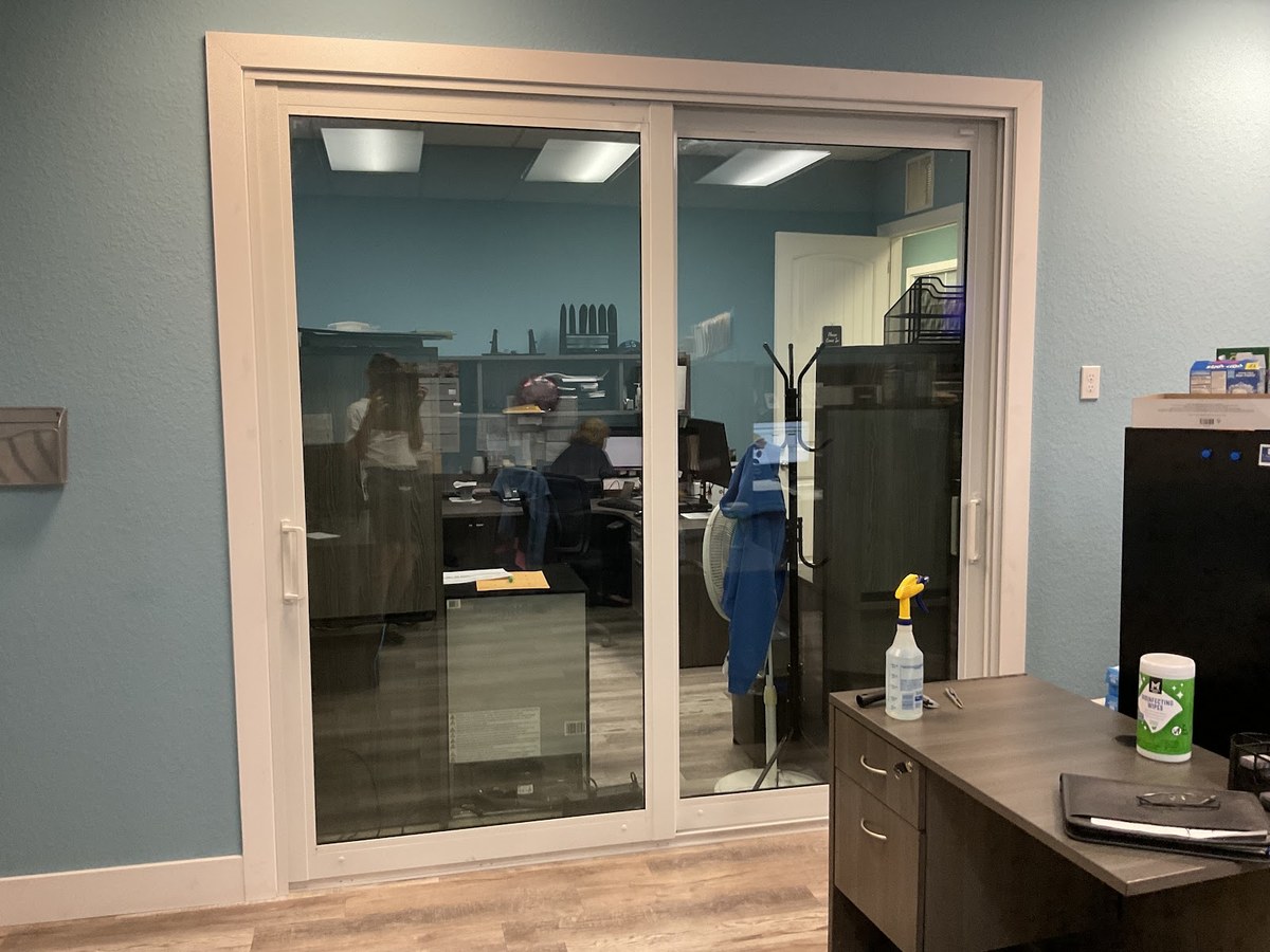 Interior office sliding-glass doors finished with dark privacy window film